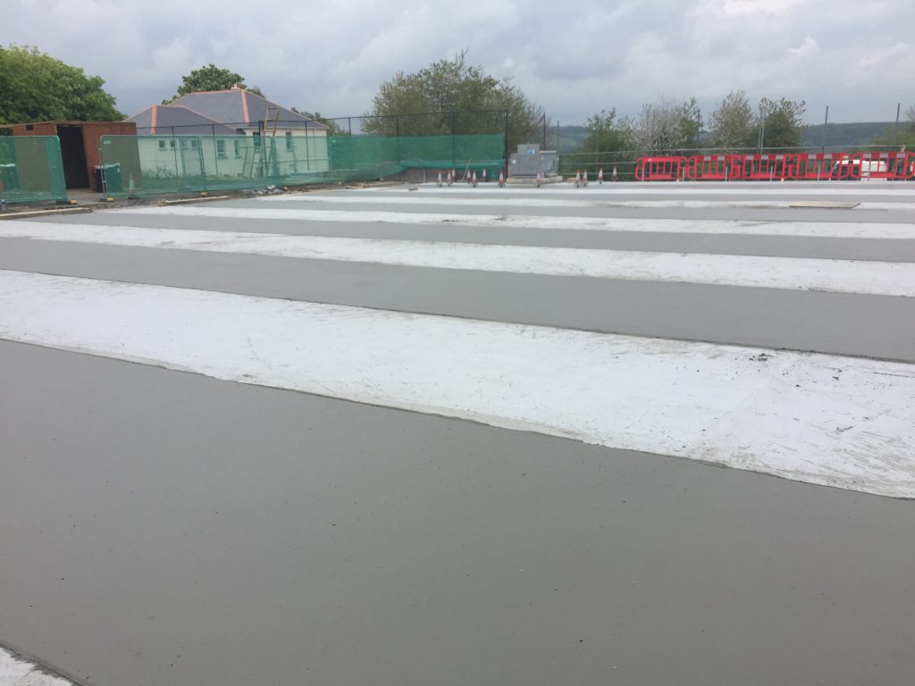 Foamed concrete screeds poured in a "hit and miss" process that enables  shuttering to be stripped from bays before placing material the following day