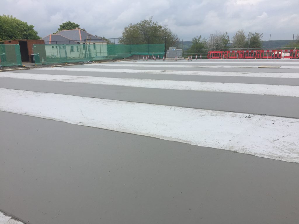 Foamed concrete screeds poured in a "hit and miss" process that enables shuttering to be stripped from bays before placing material the following day